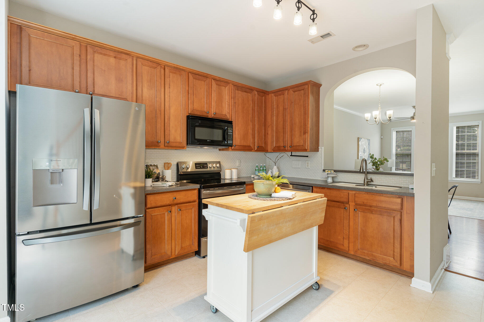 7810 Spungold Street Raleigh, NC 27617 - Photo 4 of 12 a kitchen with stainless steel appliances granite countertop a refrigerator stove microwave sink and cabinets