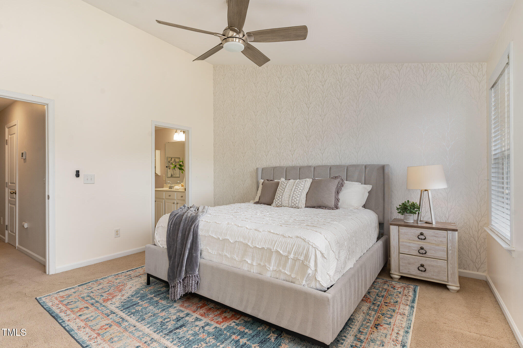 7810 Spungold Street Raleigh, NC 27617 - Photo 6 of 12 a bedroom with a bed and a chandelier