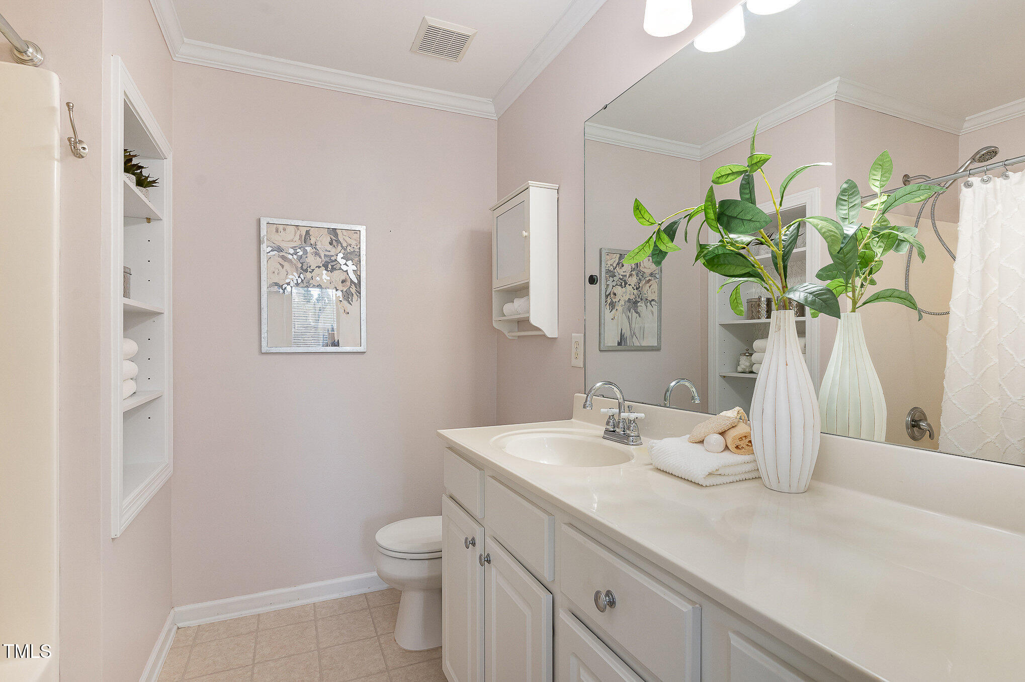 7810 Spungold Street Raleigh, NC 27617 - Photo 7 of 12 a bathroom with a granite countertop toilet a sink and a mirror