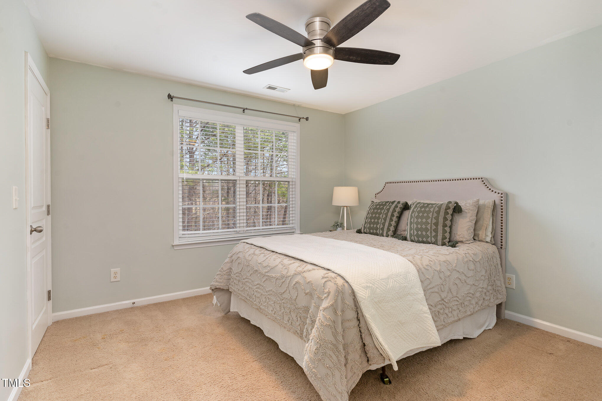 7810 Spungold Street Raleigh, NC 27617 - Photo 8 of 12 a bedroom with a bed and a large window