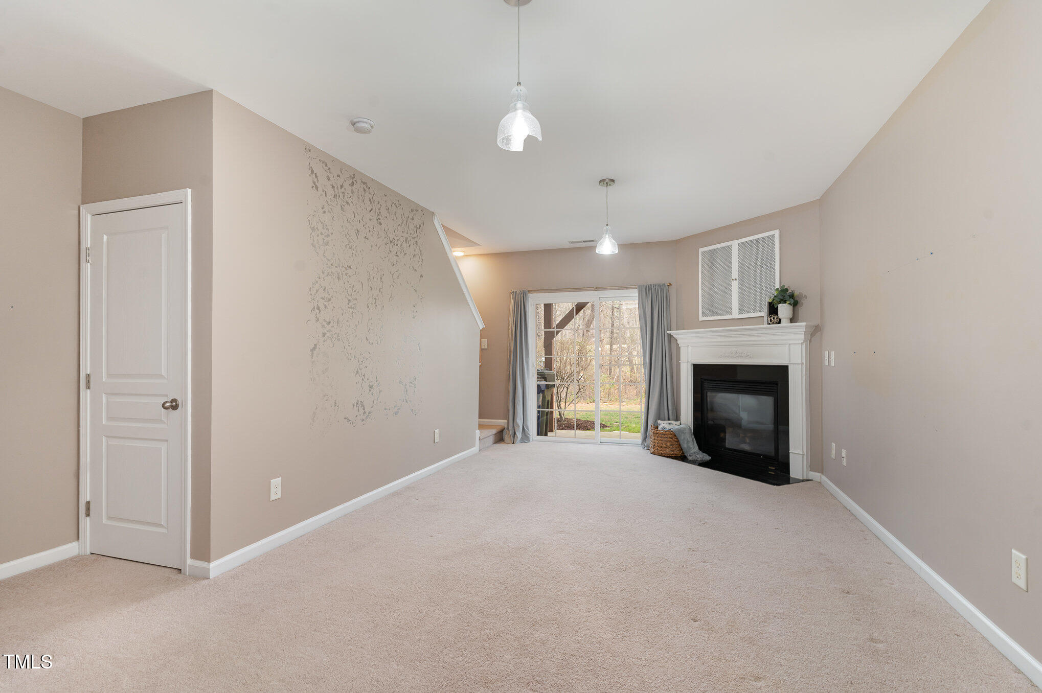 7810 Spungold Street Raleigh, NC 27617 - Photo 10 of 12 a view of empty room with a fireplace