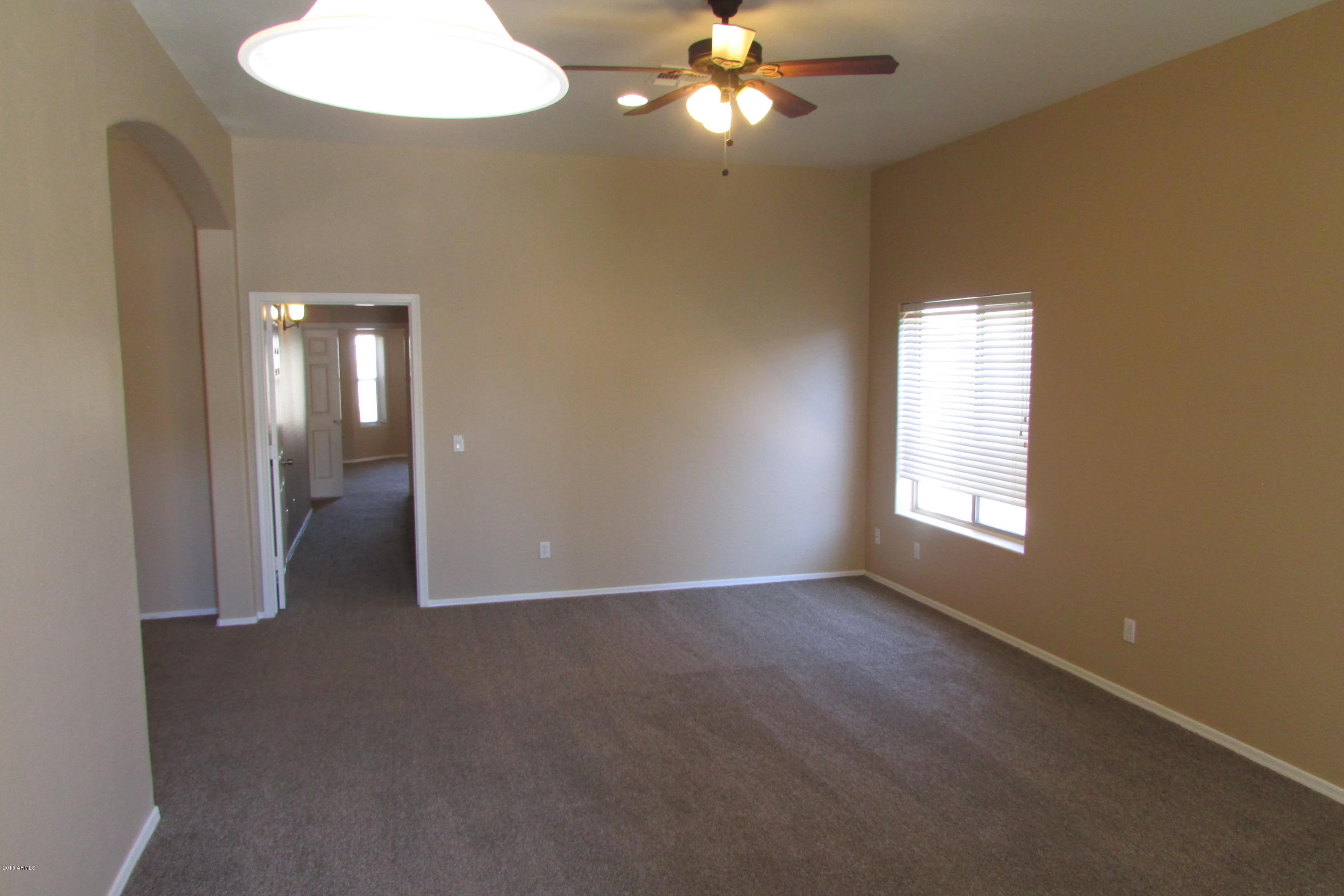 716 East Ranch Road Gilbert, AZ 85296 - Photo 3 of 22 an empty room with chandelier fan and windows