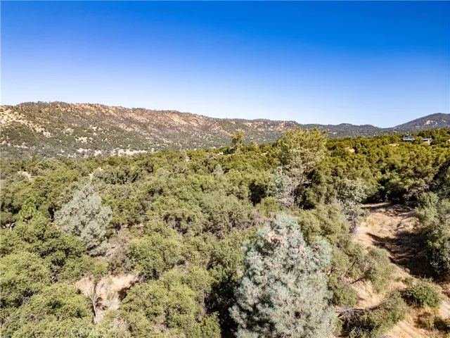 a view of a large window with mountains in the background