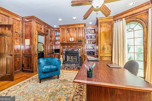 a living room with furniture a chandelier and a floor to ceiling window