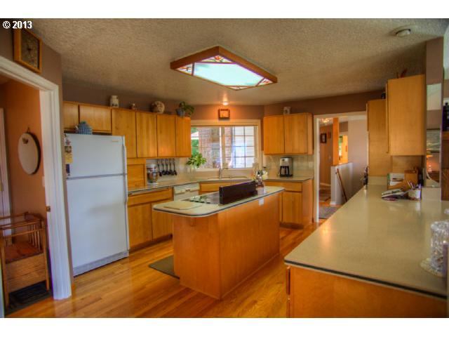 31 Stewart Road Stevenson, WA 98648 - Photo 5 of 14 a kitchen with sink a refrigerator and wooden cabinets