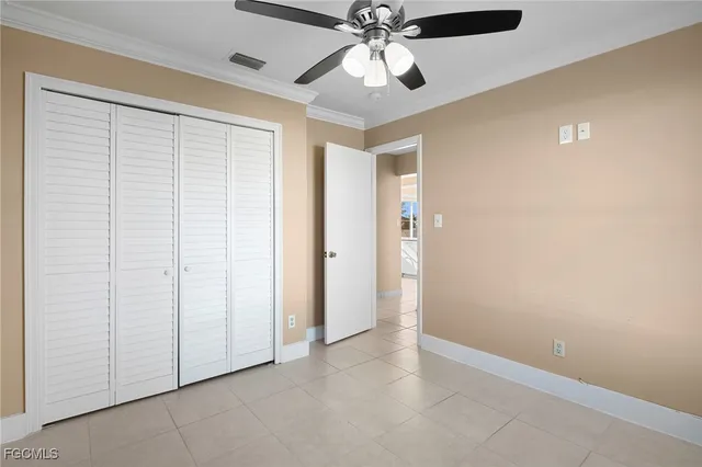 an empty room with a ceiling fan and a fan