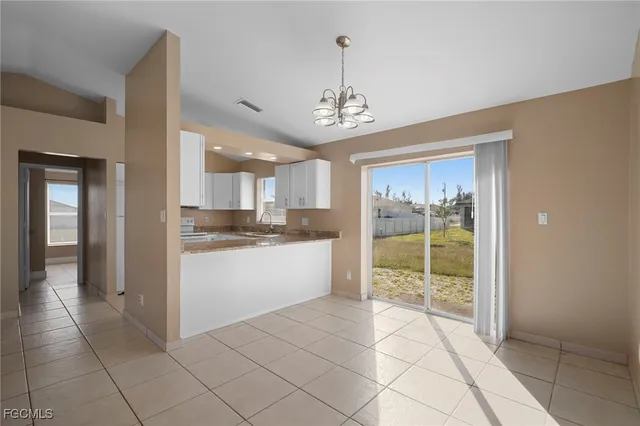 a open kitchen with a sink and refrigerator