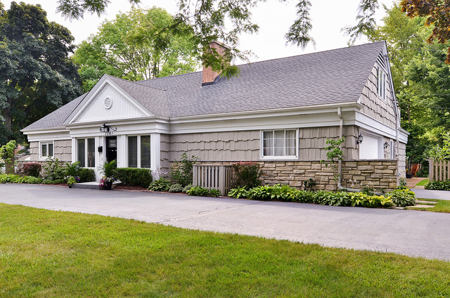 1141 Hibbard Road Wilmette, IL 60091 - Photo 1 of 20 a front view of a house with a yard and potted plants
