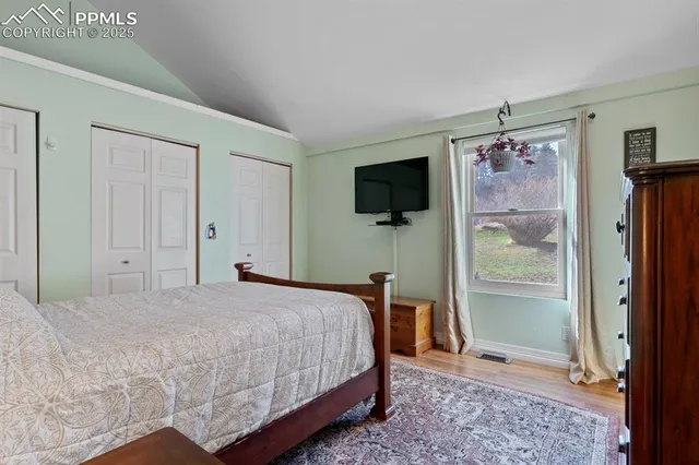 a bedroom with a bed and a flat screen tv