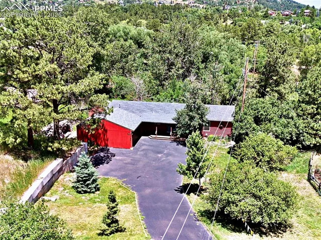 an aerial view of a house with yard swimming pool and outdoor seating