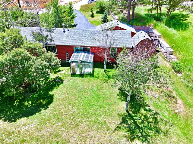 an aerial view of house with yard and outdoor seating