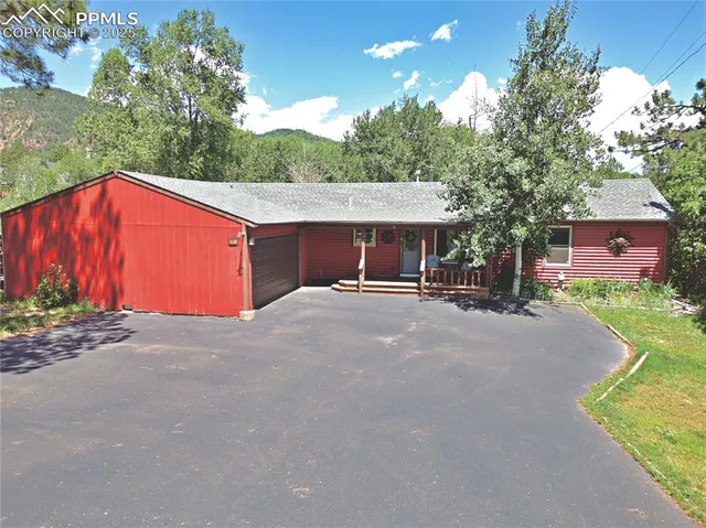 a backyard of a house with table and chairs