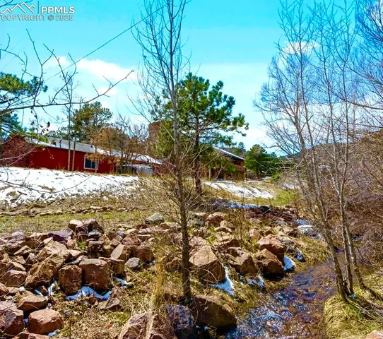 a view of a yard with snow on the road
