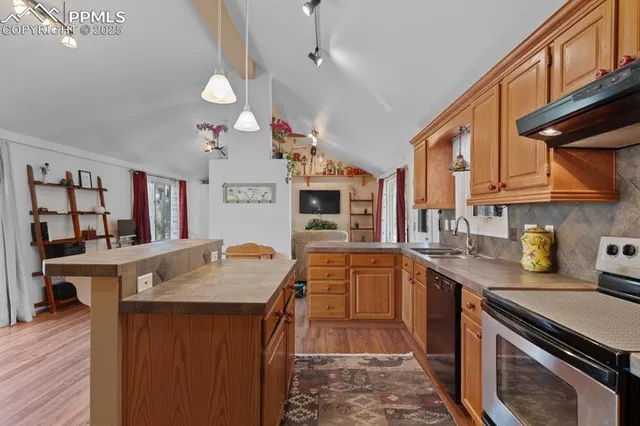 a kitchen with stainless steel appliances granite countertop a sink and cabinets