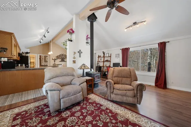 a living room with furniture ceiling fan and a rug