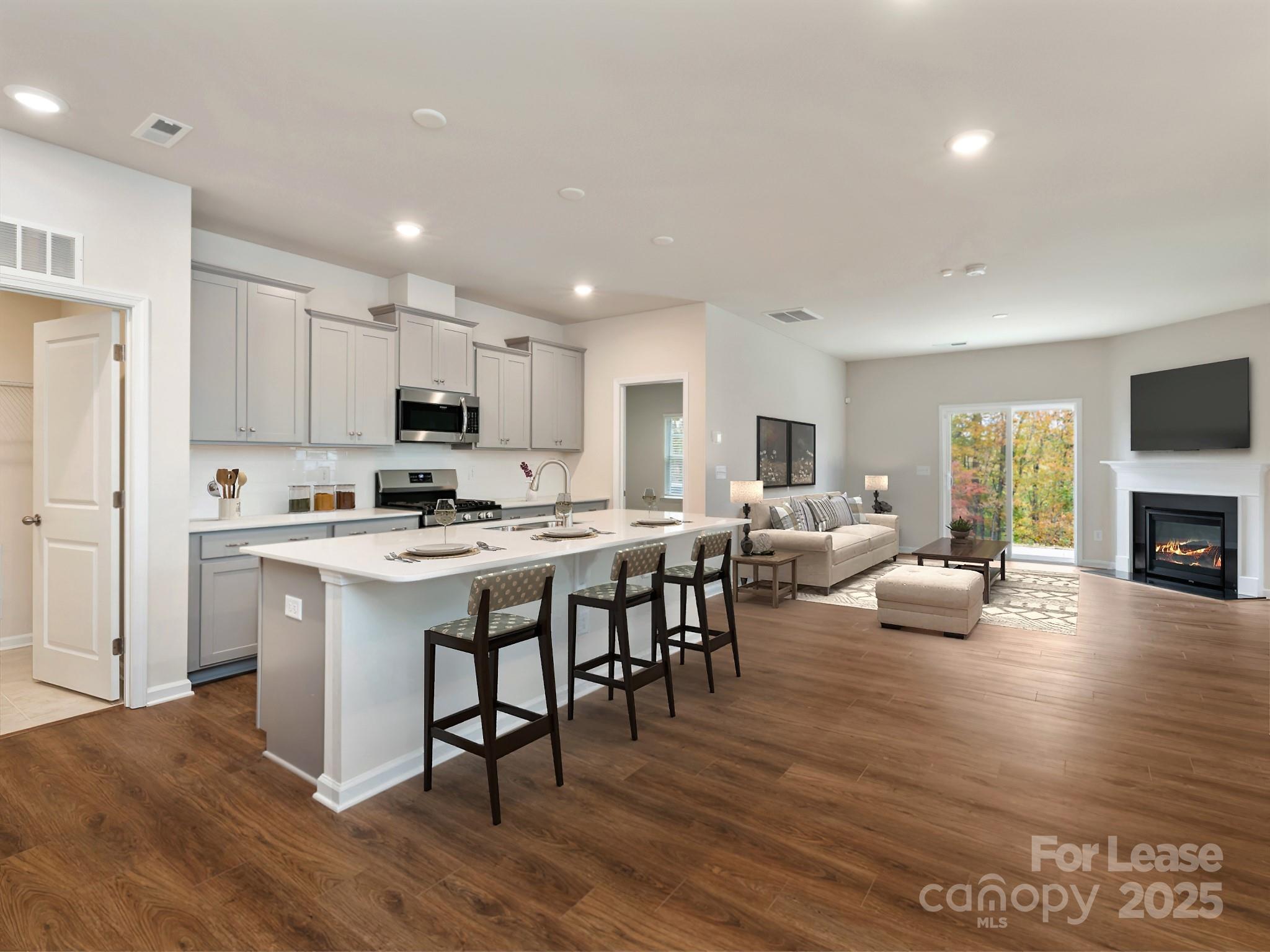 6531 Gopher Road Lancaster, SC 29720 - Photo 3 of 12 a living room with stainless steel appliances kitchen island granite countertop furniture and a fireplace