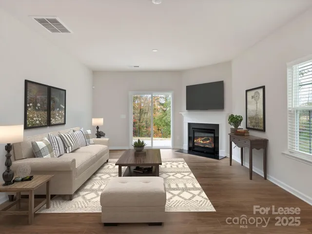 a living room with furniture flat screen tv and a fireplace