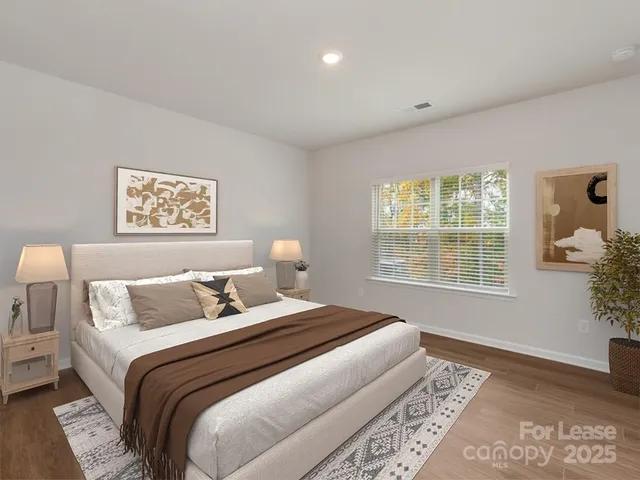 a bedroom with a large bed and a window