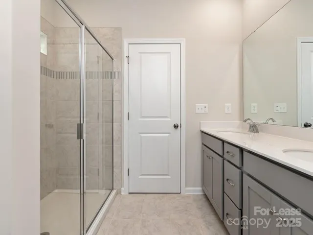 a bathroom with a shower and a sink
