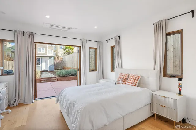 a bedroom with a large bed and a large window