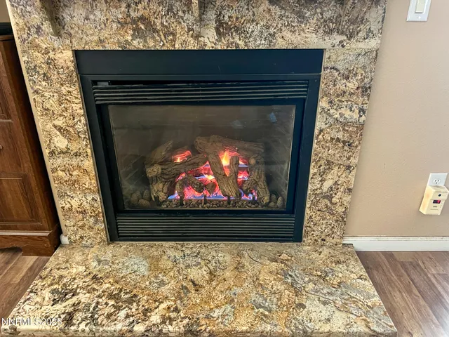 a living room with a fireplace and a rug