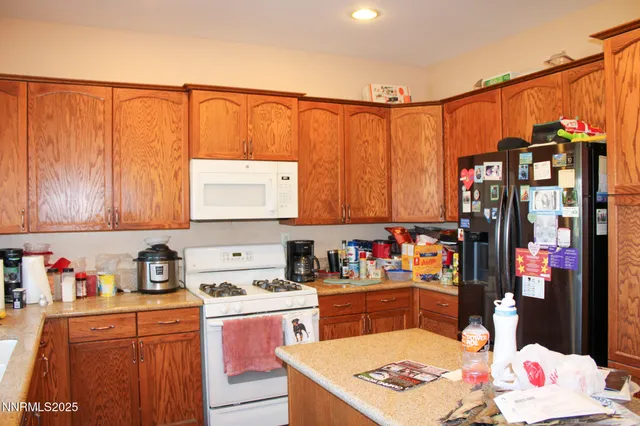 a kitchen with stainless steel appliances a sink dishwasher and cabinets with wooden floor