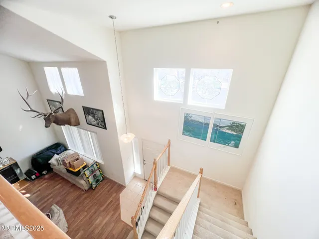 a view of a livingroom with furniture wooden floor and a window