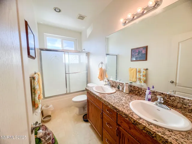 a bathroom with a sink double vanity and a mirror