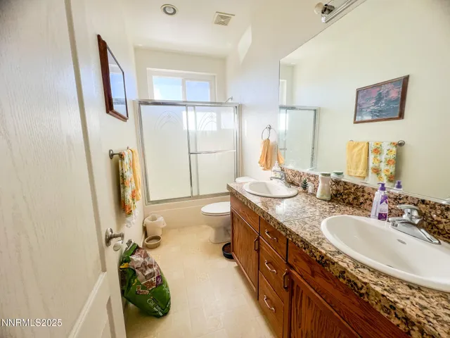 a spacious bathroom with sink a mirror a bathtub and shower
