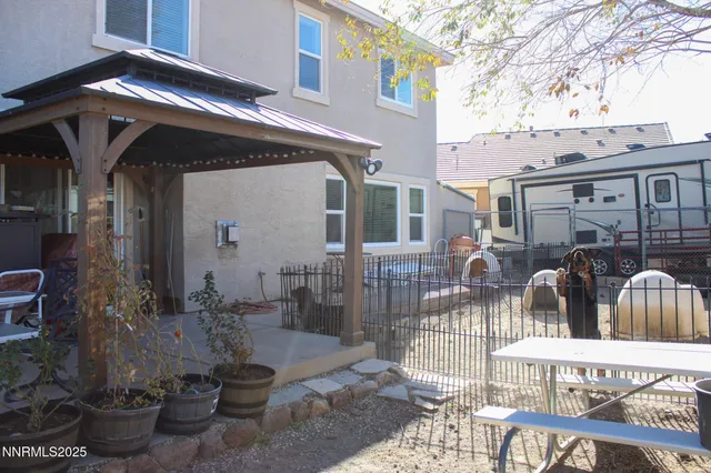 a view of a patio with table and chairs and potted plants