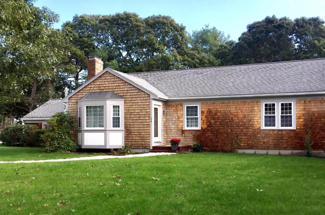 a front view of house with yard and green space