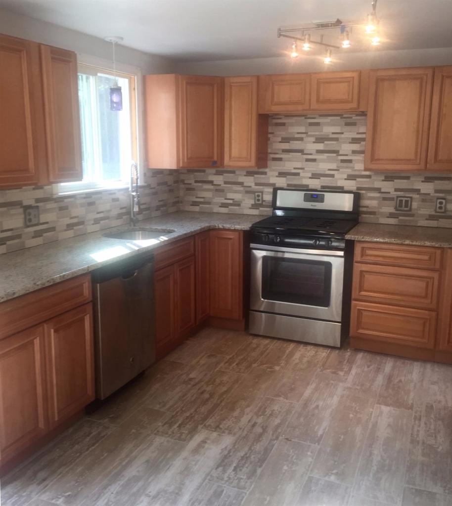 36 General Lawrence Road South Yarmouth, MA 02664 - Photo 5 of 14 a kitchen with stainless steel appliances granite countertop a stove a sink and a microwave