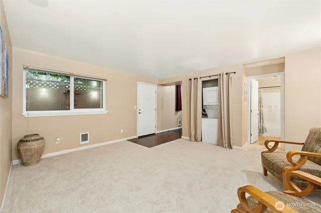 a kitchen with stainless steel appliances granite countertop a refrigerator a sink dishwasher and wooden cabinets with a large window