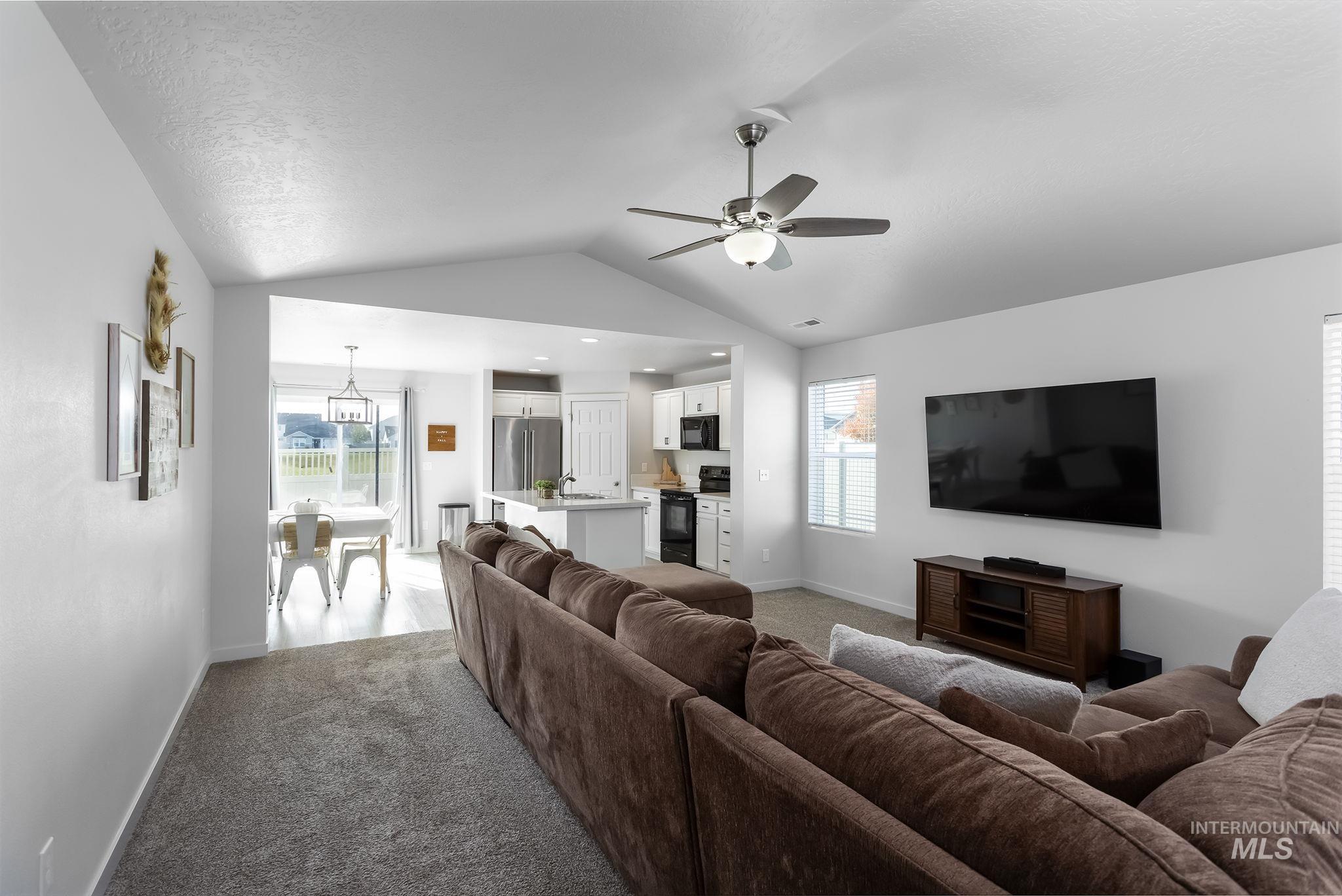 12771 Carkhill Street Caldwell, ID 83607 - Photo 5 of 13 Vaulted ceilings with a ceiling fan, plush carpet flooring, and white walls