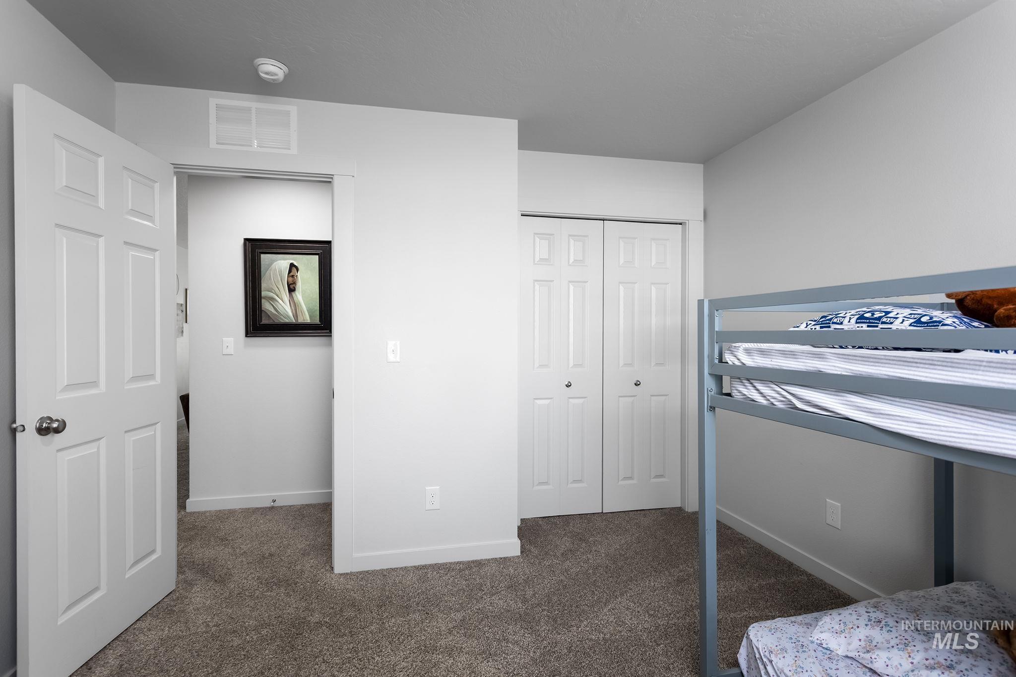 12771 Carkhill Street Caldwell, ID 83607 - Photo 10 of 13 Carpeted room with white walls, baseboards, and trim