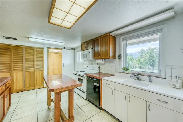 a kitchen with a sink cabinets and window