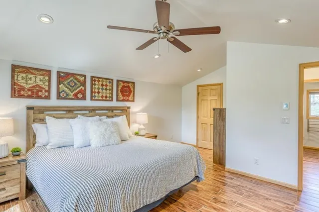 a bedroom with a bed and wooden floor