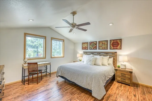 a bedroom with a bed and wooden floor