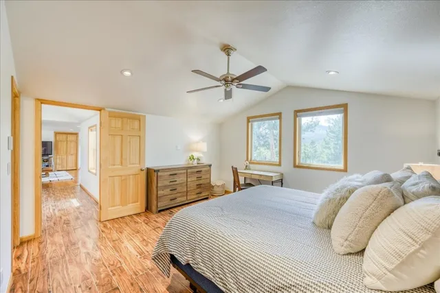 a bedroom with a bed and wooden floor