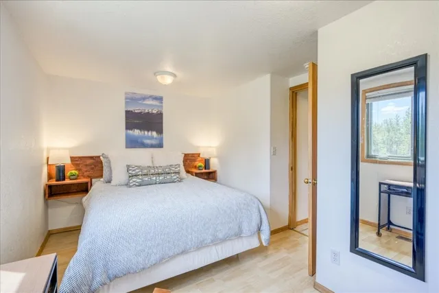 a bedroom with a bed and a lamp with window