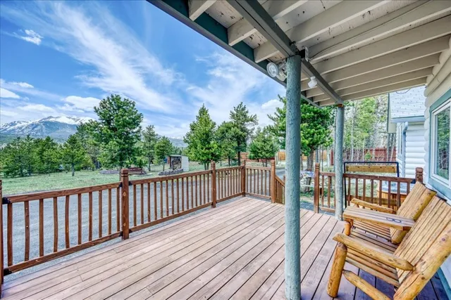 a balcony with wooden floor and furniture