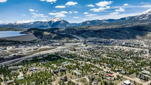 an aerial view of a house with a yard and a tree