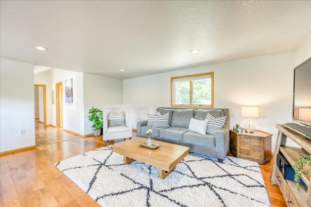 a living room with a couch and a table with wooden floor