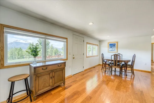 a view of a dining room with furniture window and wooden floor