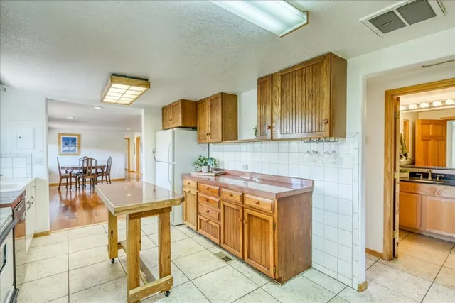 a kitchen with stainless steel appliances granite countertop a stove and cabinets