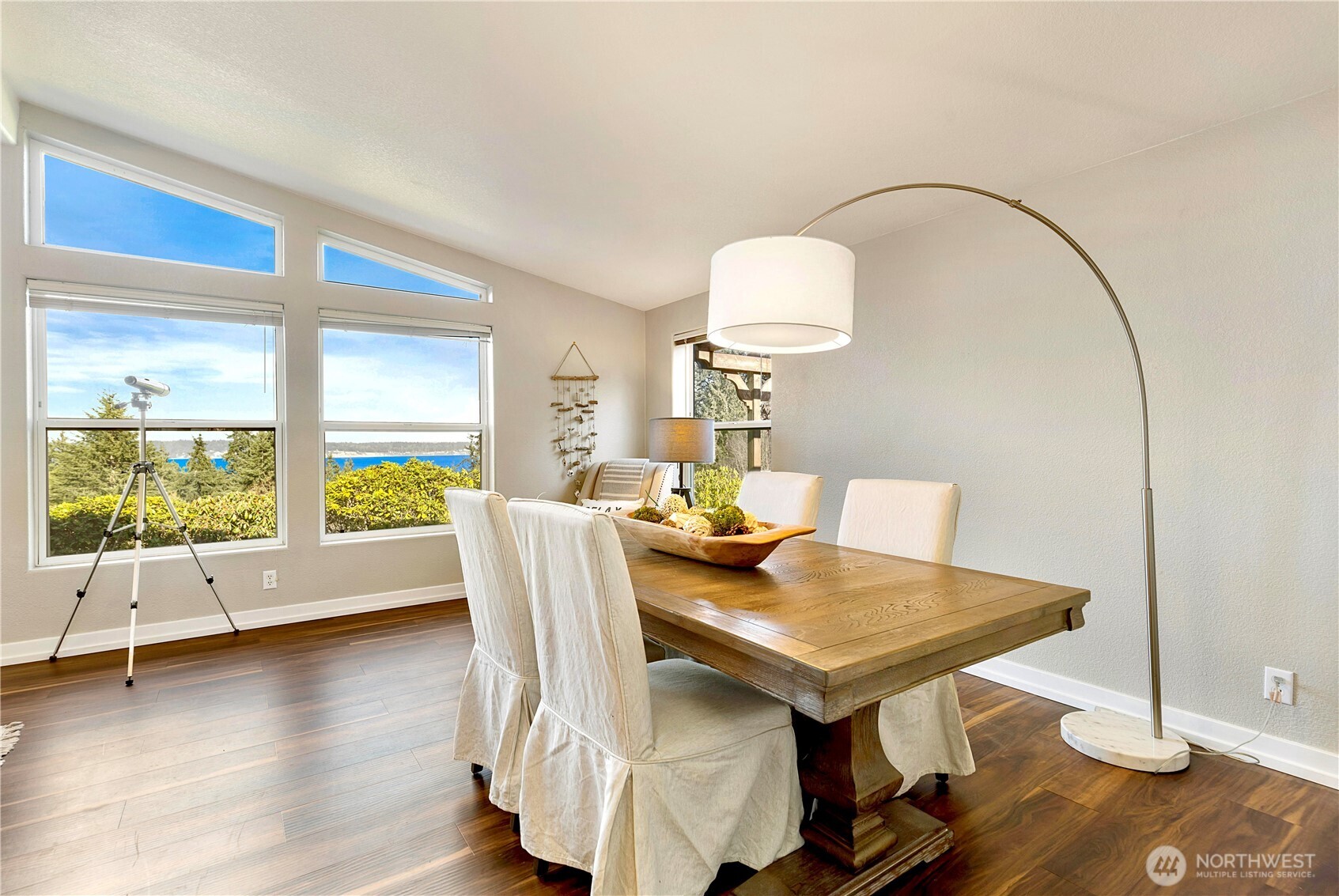 3834 South Passage View Lane Langley, WA 98260 - Photo 12 of 40 a view of a dining room with furniture a chandelier and wooden floor