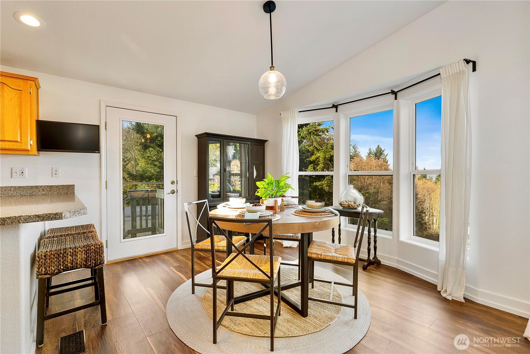 3834 South Passage View Lane Langley, WA 98260 - Photo 16 of 40 a view of a dining room with furniture window and wooden floor