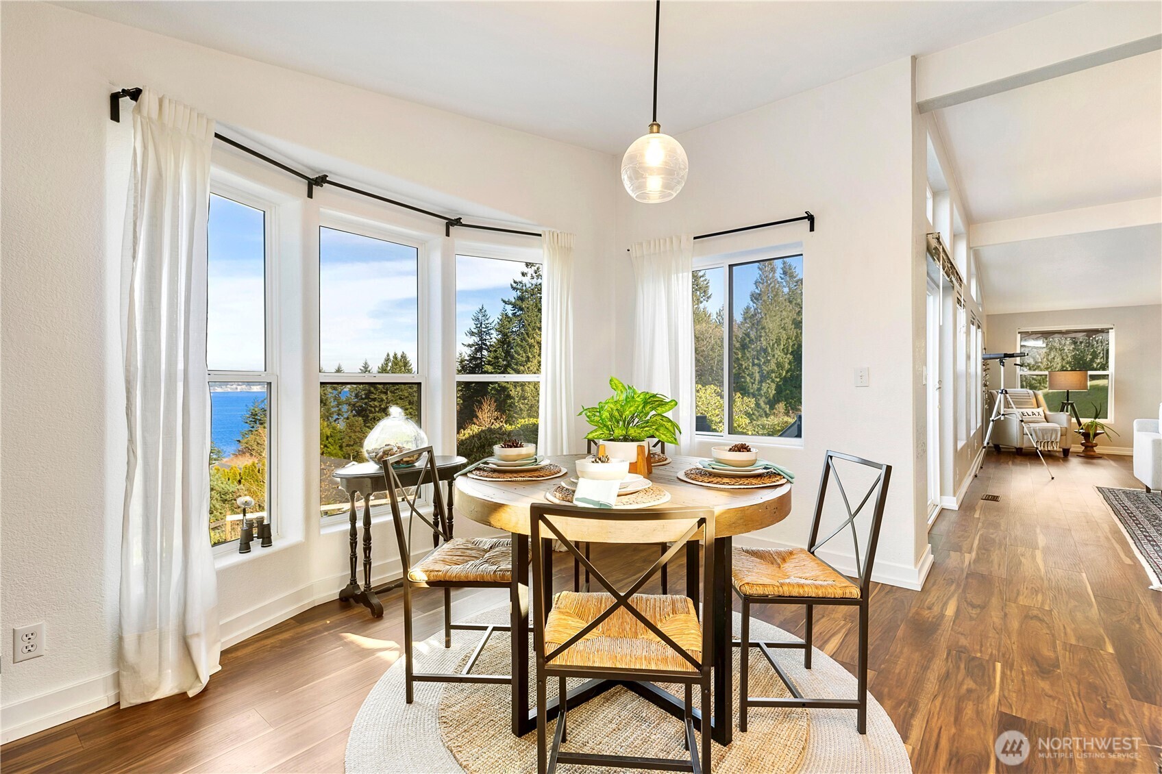 3834 South Passage View Lane Langley, WA 98260 - Photo 17 of 40 a view of a dining room with furniture and wooden floor