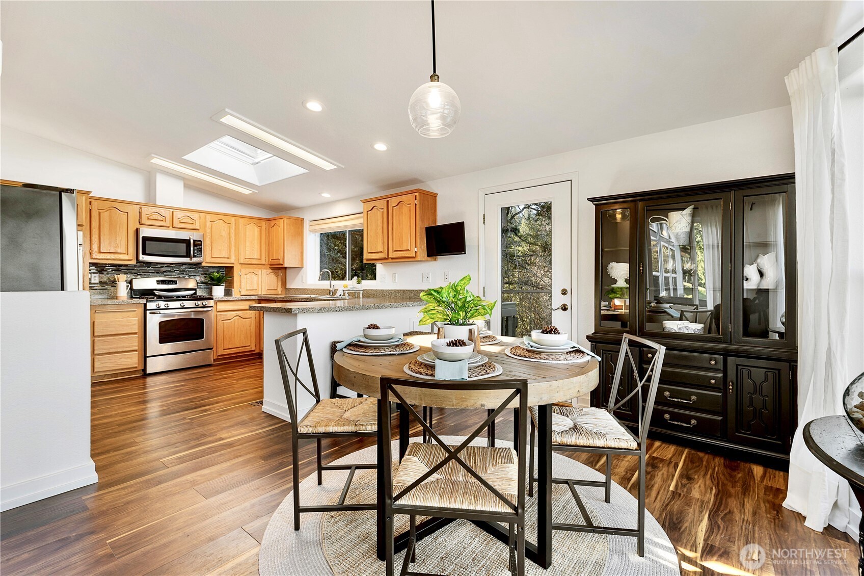 3834 South Passage View Lane Langley, WA 98260 - Photo 19 of 40 a dining room with furniture and wooden floor