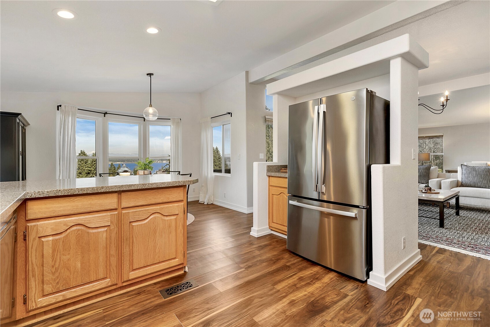 3834 South Passage View Lane Langley, WA 98260 - Photo 21 of 40 a kitchen with stainless steel appliances a refrigerator and wooden floor